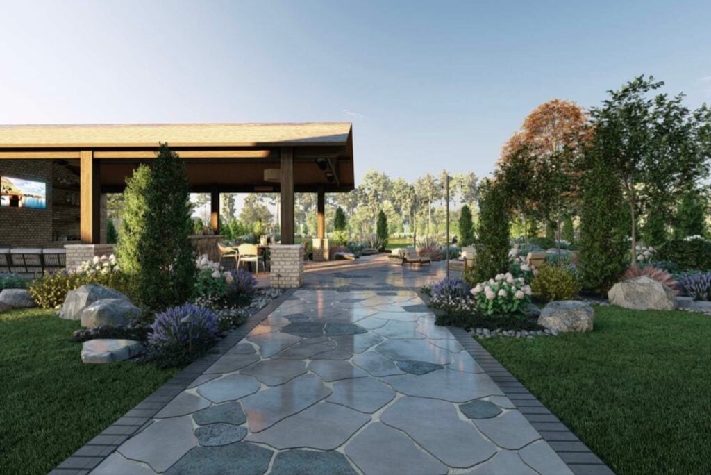 A stone walkway leads through landscaped gardens to a covered outdoor structure with seating, showcasing thoughtful landscape design and lush greenery—perfect inspiration for your next backyard remodel.
