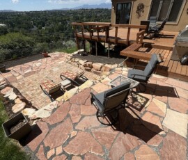 Flagstone Patio, Rock Retaining Wall, Grass, Sprinklers, Mulch, Plants
