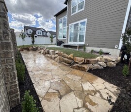 Flagstone Patio, Rock Retaining Wall, Grass, Sprinklers, Plants and Trees, Mulch