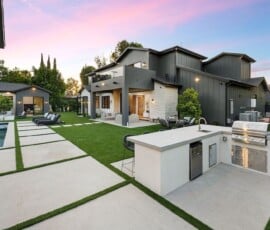 Modern backyard featured on the homepage, with outdoor kitchen, built-in grill, seating area, pool, and contemporary house surrounded by landscaped greenery at sunset. Modern backyard featured on the homepage, with outdoor kitchen, built-in grill, seating area, pool, and contemporary house surrounded by landscaped greenery at sunset.