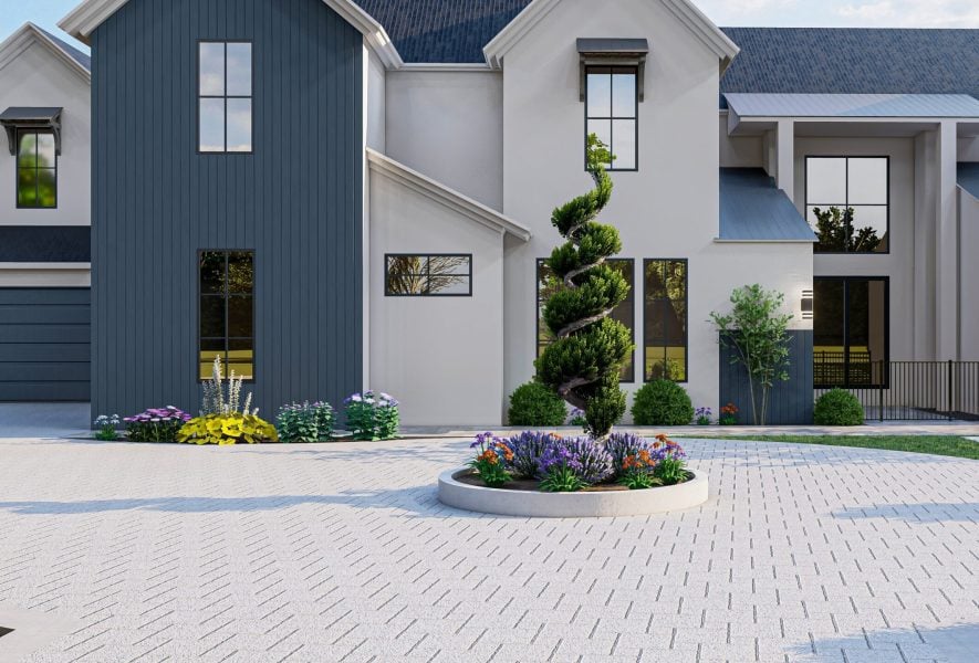 Modern house exterior with white walls, tall windows, and a circular paver driveway featuring a spiral-shaped topiary surrounded by colorful flowers and shrubs—perfect for showcasing expert driveway installation.